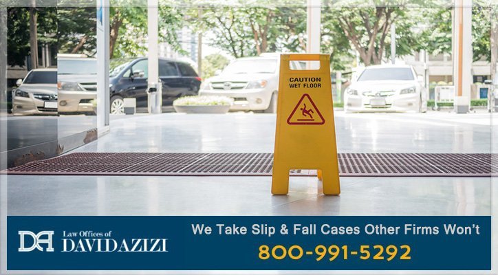 A caution wet floor sign located near a grate.