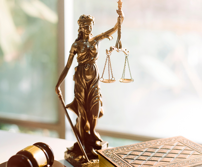 Law and justice statue over desk