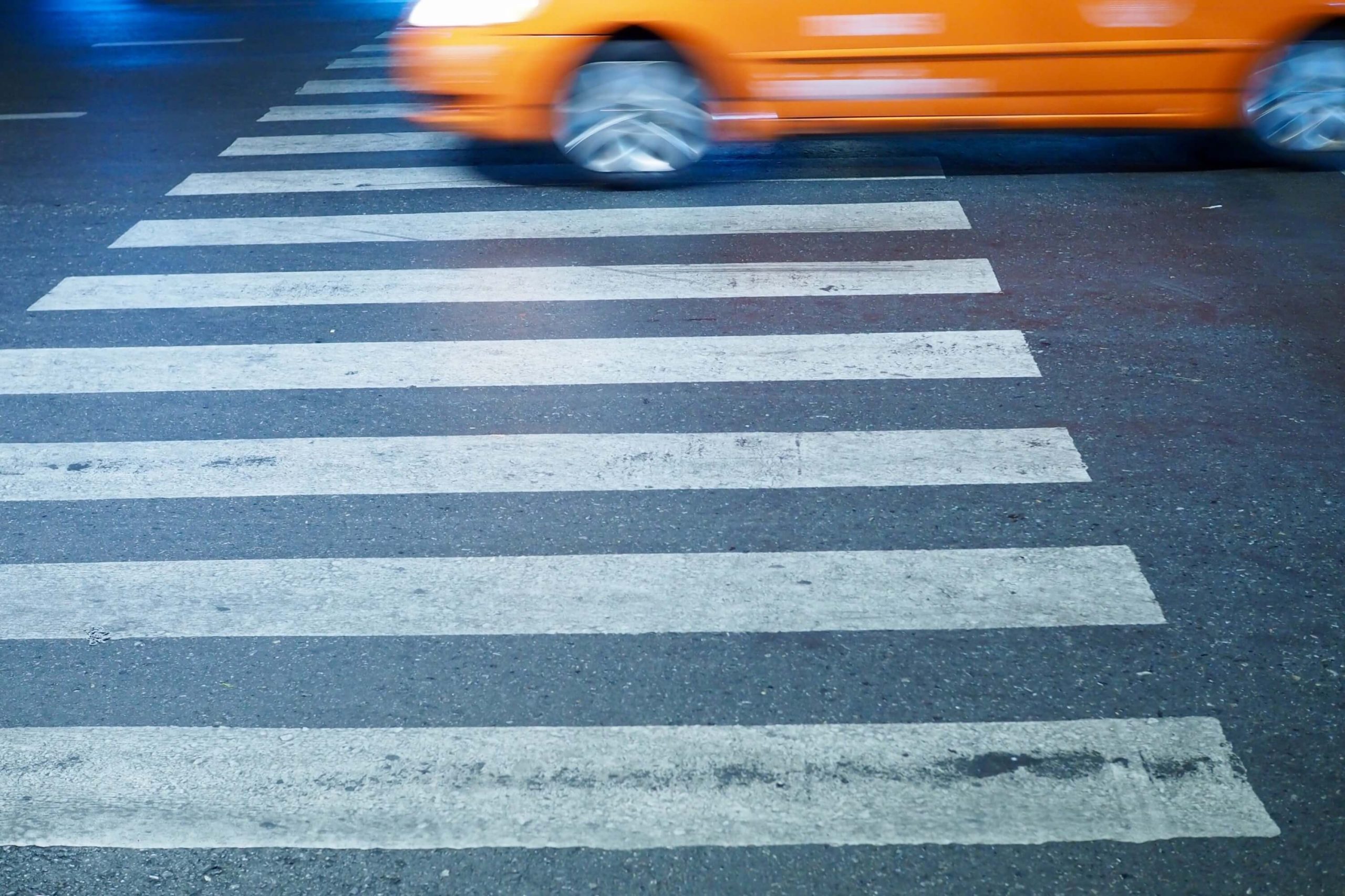 Pedestrian accident with orange car in the background
